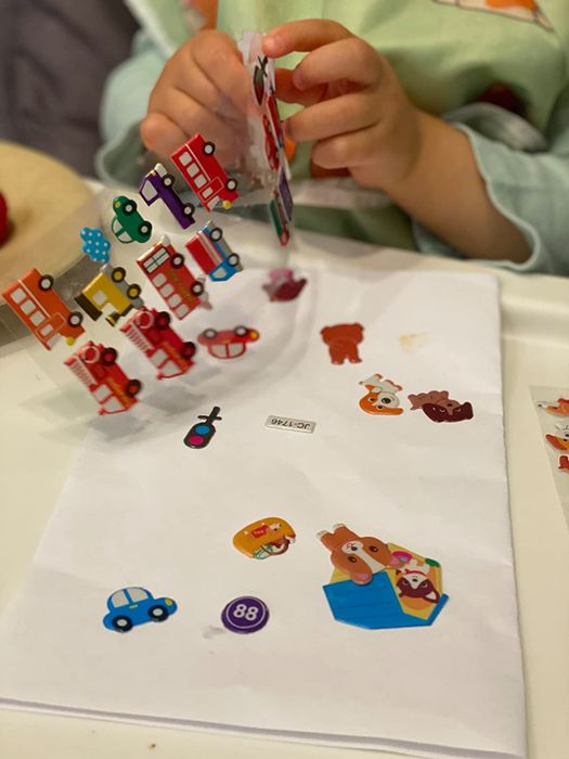 A child playing with puffy stickers