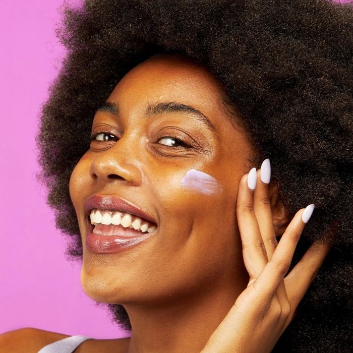 model gently massaging the moisturizer into her skin