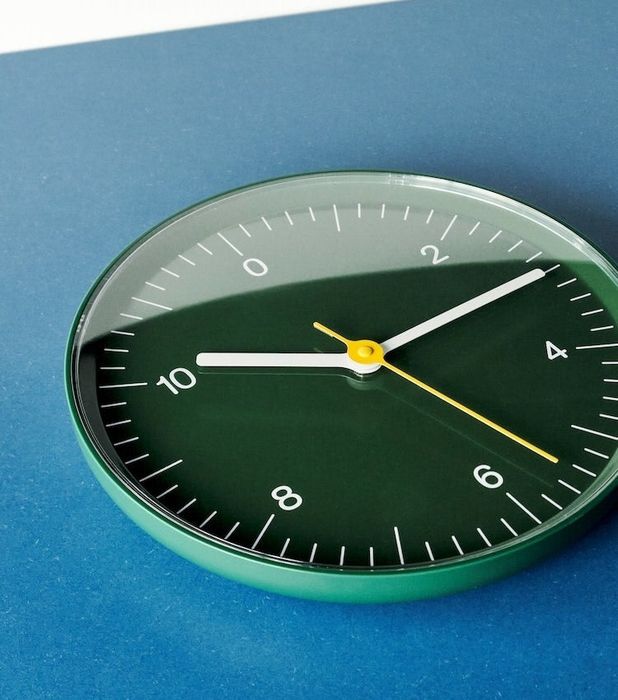 green wall clock with only even numbers marked