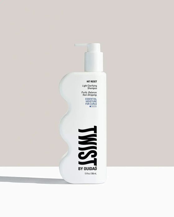A white, curvy shampoo bottle with the label clearly visible.