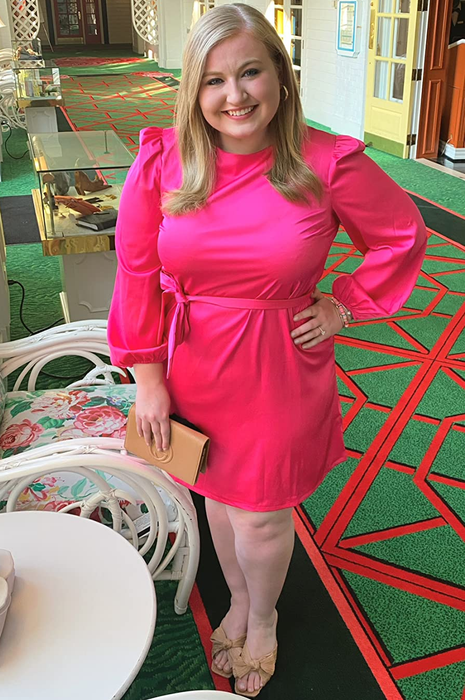 A reviewer showcasing the pink dress paired with tan heels