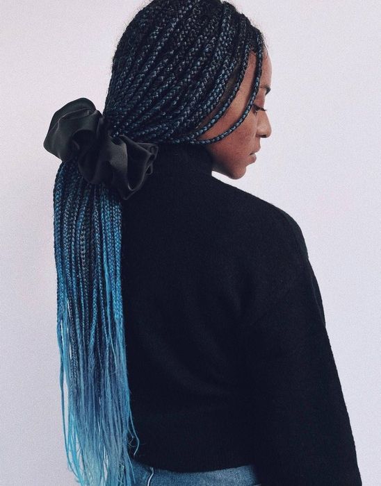 Model sporting a black scrunchie with black and blue hair