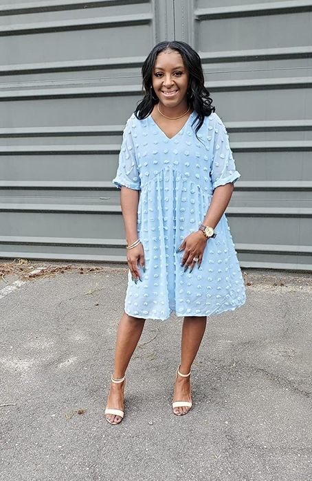 A reviewer wearing the same mini dress in blue