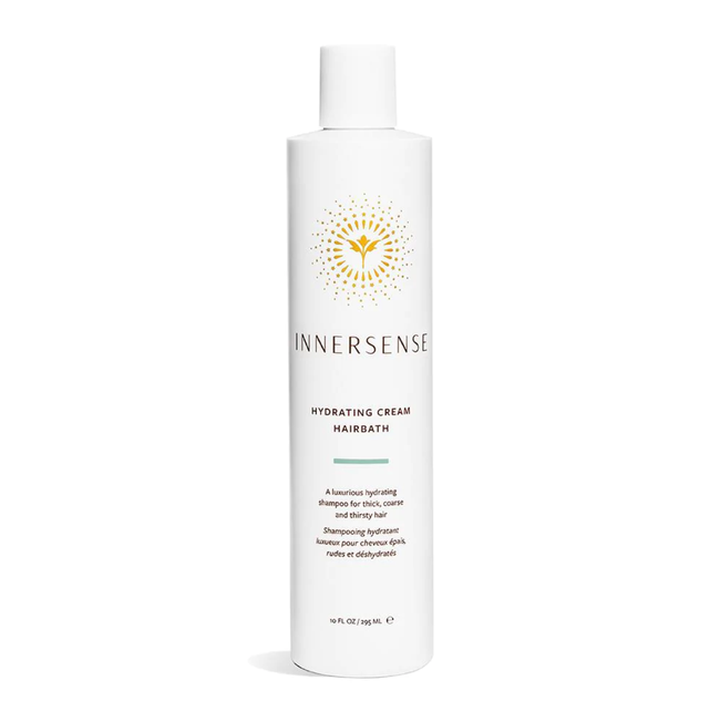 White, narrow bottle of shampoo with the label.