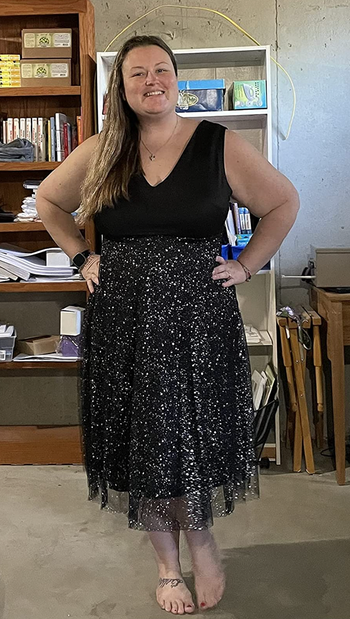 A reviewer wearing the dress in sleek black.