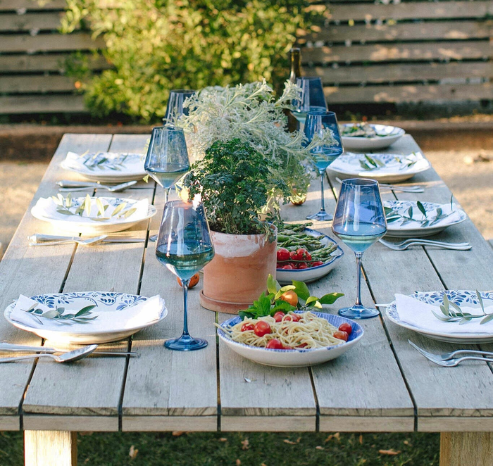 six cobalt blue wine glasses arranged neatly on a table