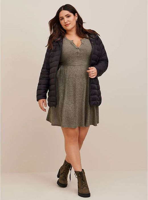 a model in the same dress, but in dark green