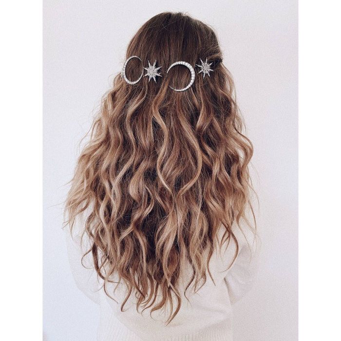 Model with wavy hair styled with decorative clips