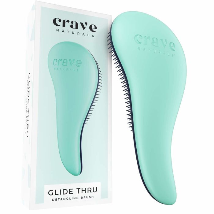 The ergonomically designed turquoise brush