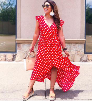 A reviewer sporting the red version of the dress, also with white polka dots