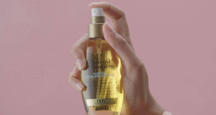 Model holding a yellow spray bottle