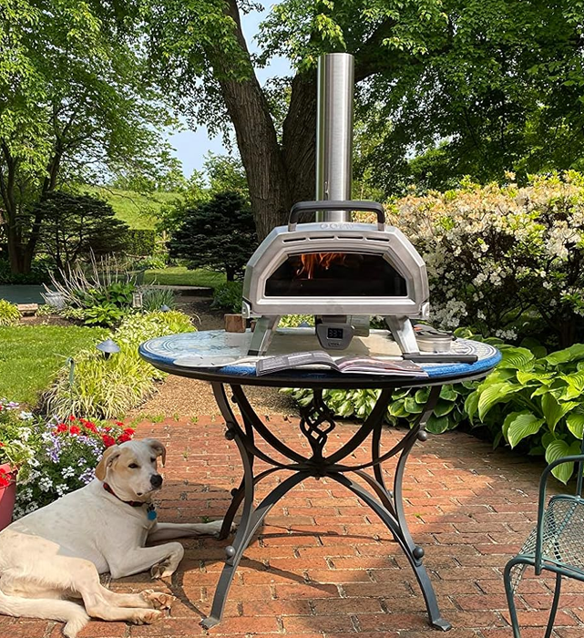 A reviewer's oven set up on a table in their backyard