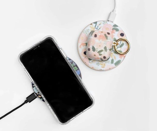 Two round floral-patterned chargers, one with a phone on top and the other with AirPods placed on it.