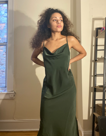 A reviewer wearing the dress in a rich forest green shade.
