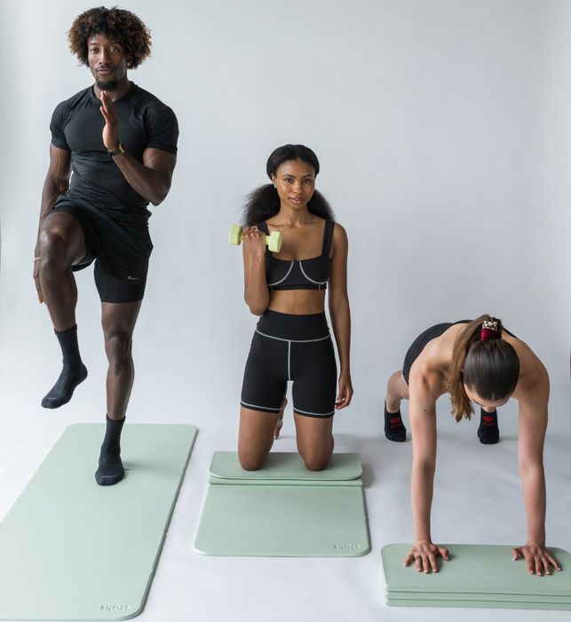Models demonstrating the green mat, both unfolded and folded, to showcase its versatile use.