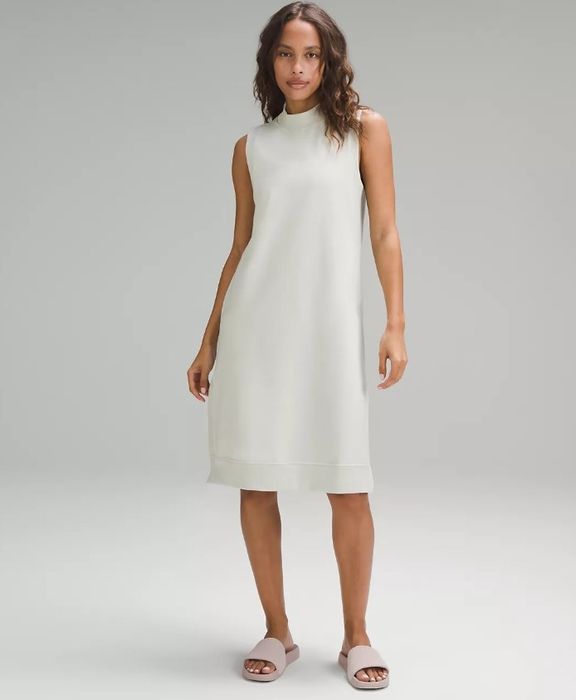A model is wearing the white terry cloth dress
