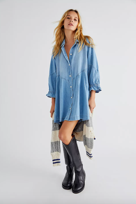 A model wearing a button-up denim midi dress with 3/4 length sleeves