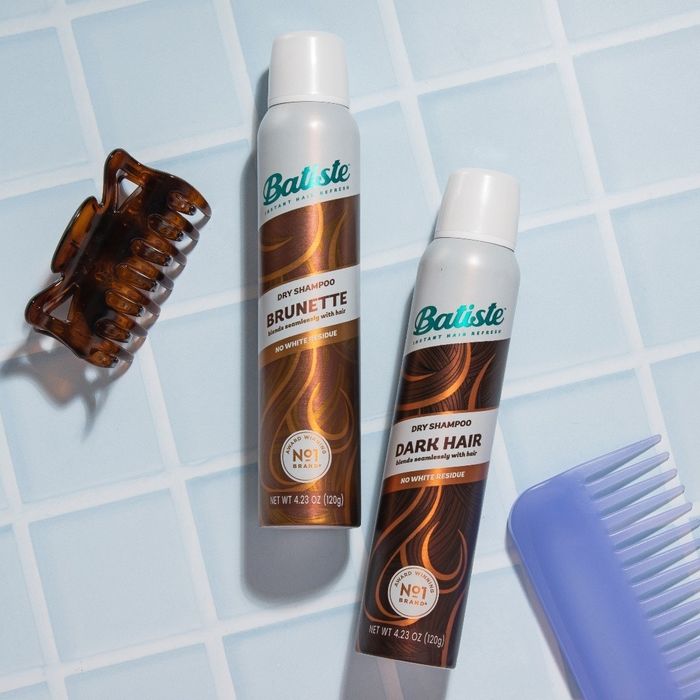 Two bottles of dry shampoo in brunette and dark hair shades