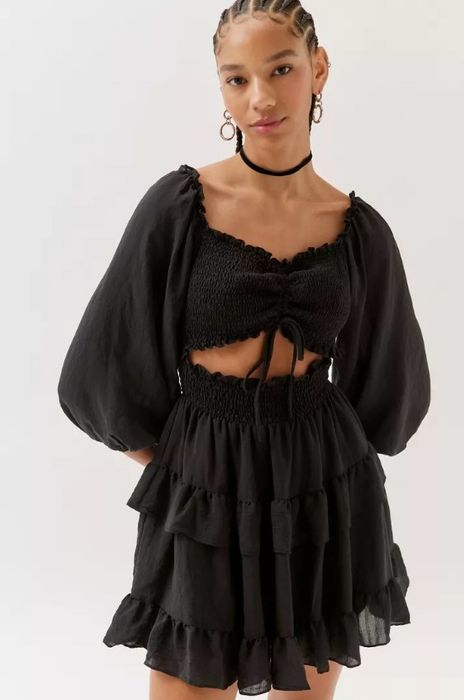 A model rocking the black cut-out mini dress