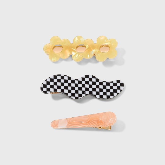 A yellow, black, white, and peach hair clip