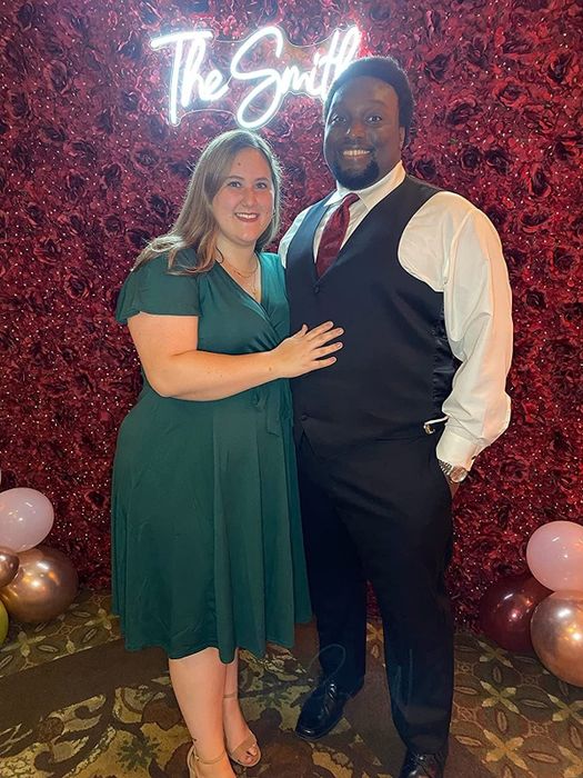A reviewer wearing the dress in green