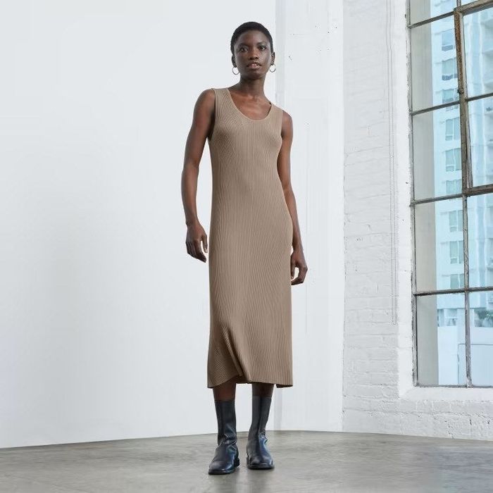 The model is showcasing the dress in a rich brown shade.