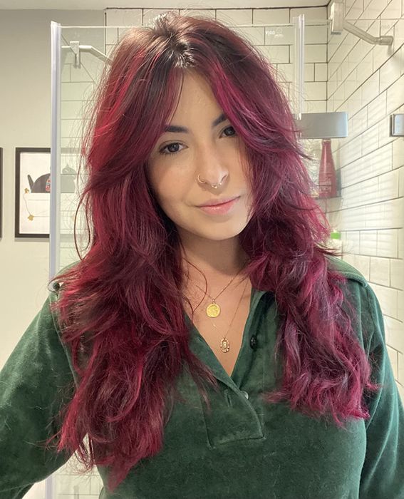 A reviewer's vibrant burgundy hair after using the dye