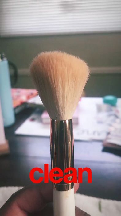 A freshly cleaned makeup brush, ready for use.