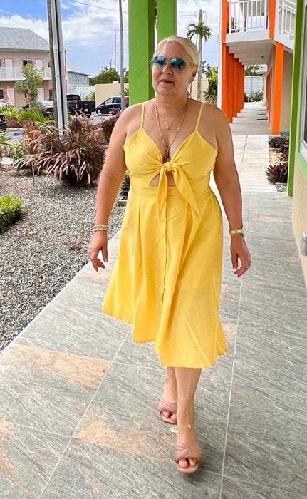 A review photo of the yellow dress featuring a bow tie in the middle.