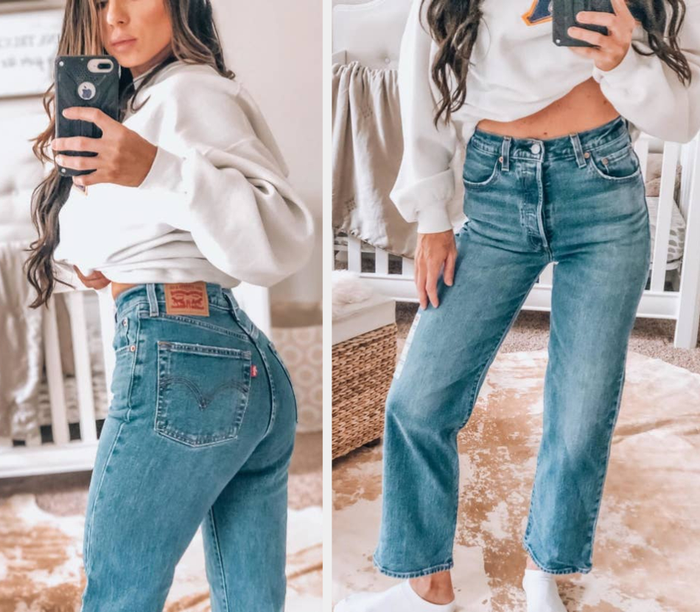 A reviewer wearing the jeans in a medium blue wash.