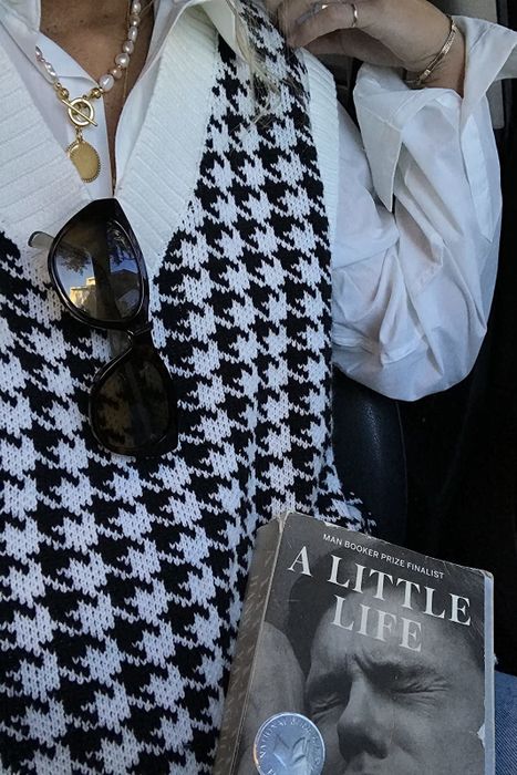 A reviewer is dressed in the sweater in a sleek black color.