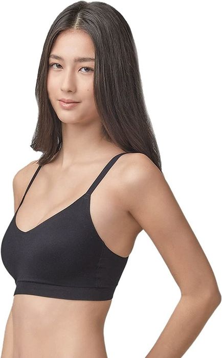 A model is seen wearing the black version of the Floatley seamless bra.