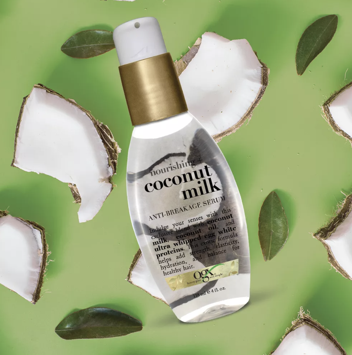 The serum in a transparent bottle surrounded by crushed coconuts