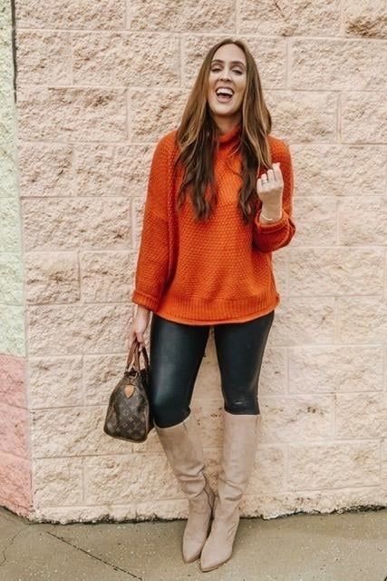 Another reviewer wearing the sweater in orange.