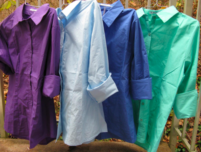 A customer showcases the shirts hanging in several colors.