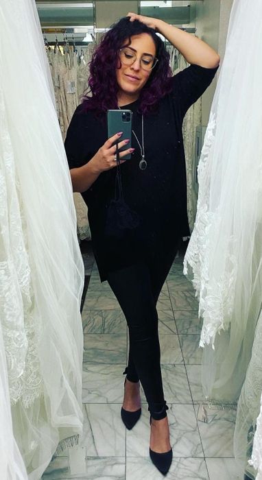 A reviewer wearing the pants in black.