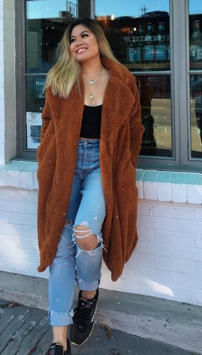 A reviewer wearing the coat in a rich caramel shade.