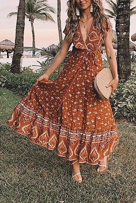 A model wearing the ruffled sleeve maxi dress in tangerine.