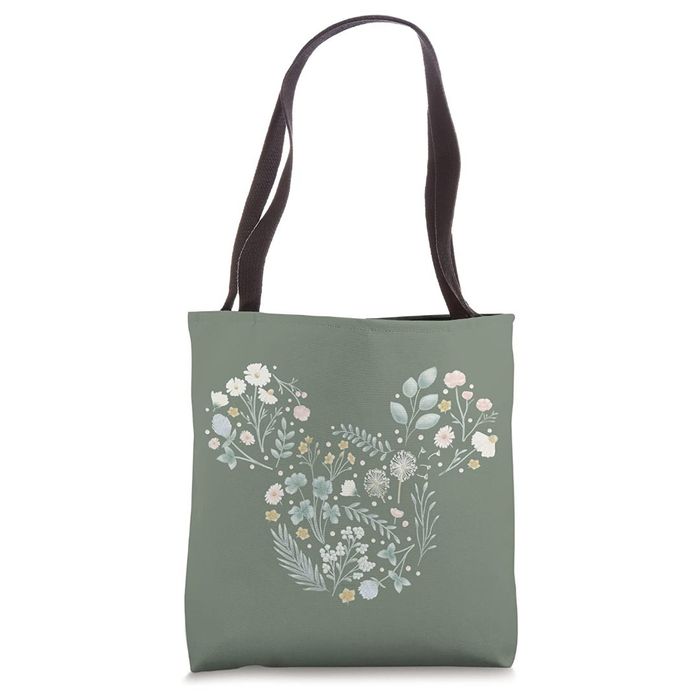 a sage green tote bag adorned with Mickey Mouse formed from a floral design