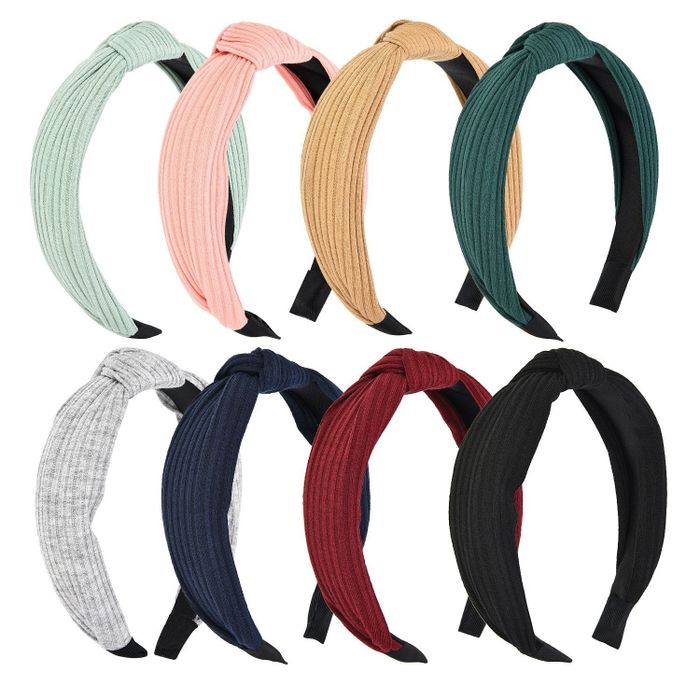 A product shot displaying eight headbands in various colors.