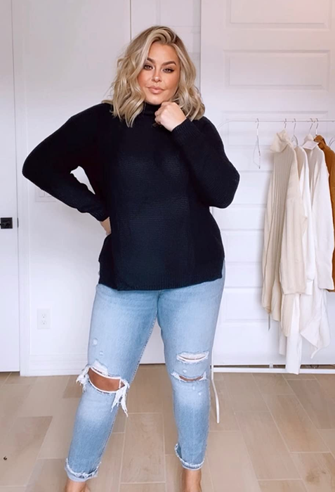 A reviewer sporting the sweater in black.