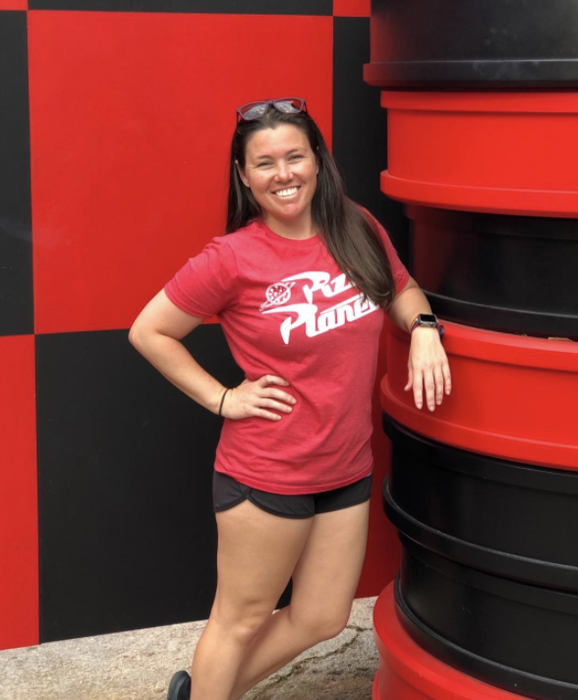 a reviewer rocking a red Pizza Planet tee with its logo