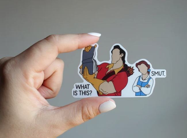 a sticker of Gaston holding Belle's book with the phrase