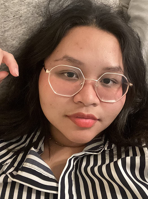 A reviewer showing off the deep rose shade of the lip stain on their lips