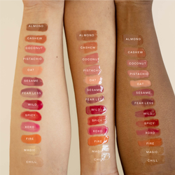 A model's arms showcasing multiple swatches of the lip gloss.