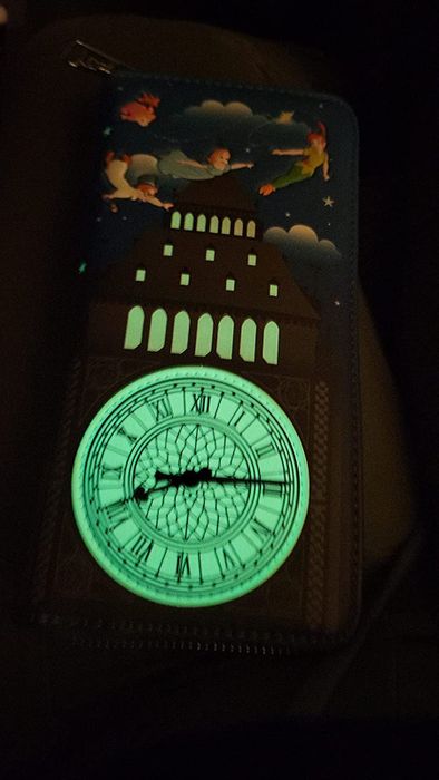 a reviewer's Peter Pan wallet glowing brightly in the dark