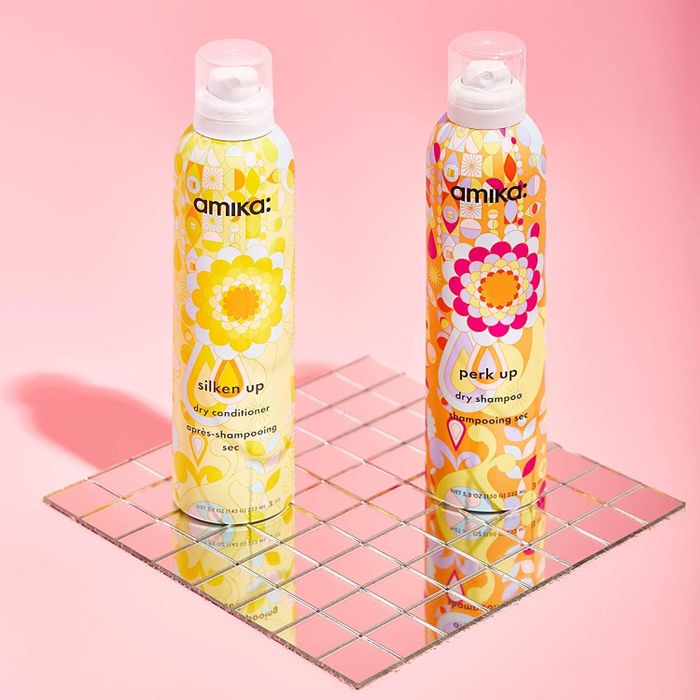 Bottles of Amika dry shampoo and conditioner.