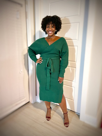 A reviewer wearing the dress in a lovely green shade.