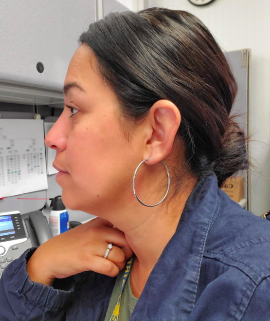 A customer review photo of them wearing the hoop earrings.