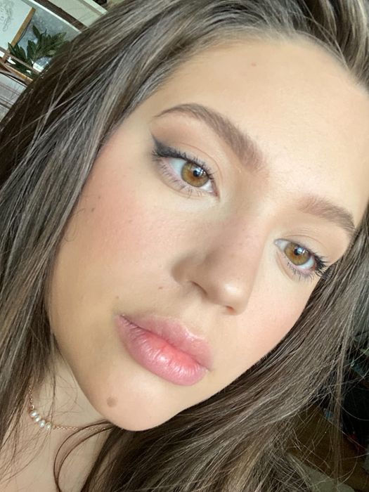 reviewer selfie wearing the tinted moisturizer with makeup applied
